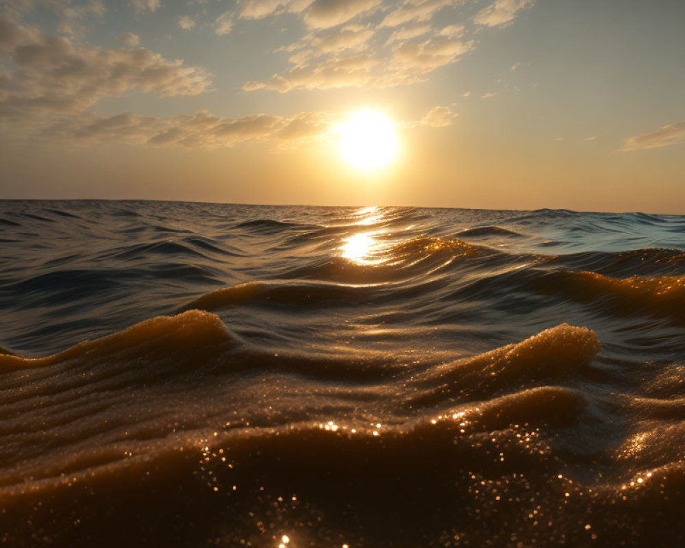 Tranquil sea sunset with gentle cresting waves.