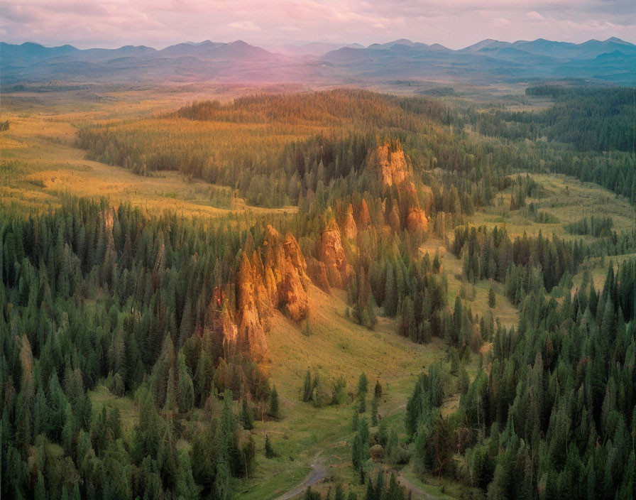 Scenic sunset view of forested hills and rock formations