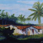 Scenic tropical village with white houses, thatched roofs, palm trees, and misty mountains