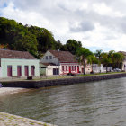 Scenic Coastal Village: White Houses, Green Cliffs, Blue Sea