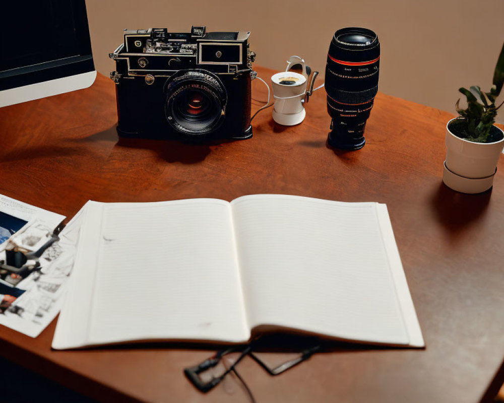 Vintage camera, lens, coffee cup, notebook, and photos on wooden desk