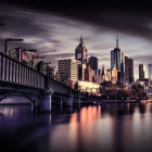 Colorful Nighttime Cityscape with Reflective River & Lit-Up Bridge