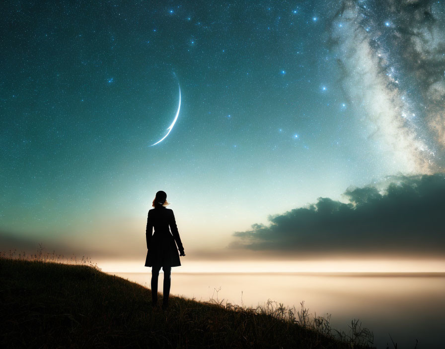 Silhouette of person on grassy hill under starry night sky by tranquil water