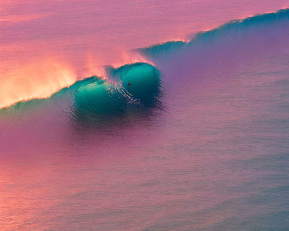 Surfer riding vibrant pink and purple wave at sunset