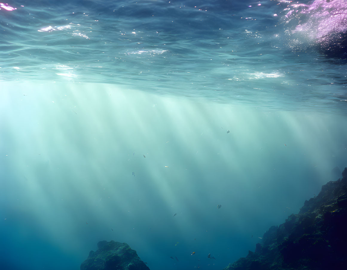 Clear Blue Water: Sunlight Filtering, Rocks, Small Fish