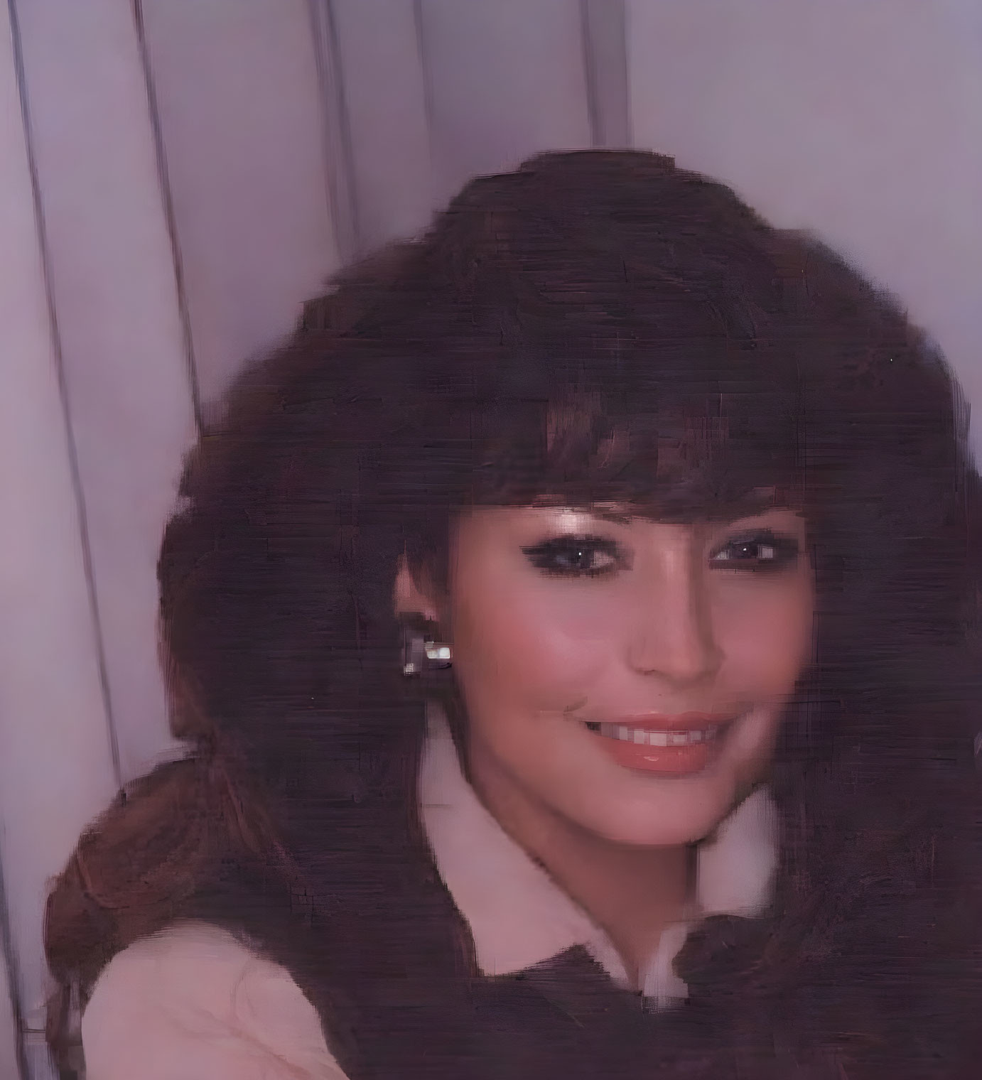 Portrait of a Woman with Dark Hair and Large Earrings Smiling Warmly