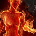 Flaming female figure against dark backdrop portrays heat and motion