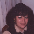 Portrait of a Woman with Dark Hair and Large Earrings Smiling Warmly