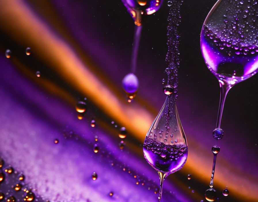 Water droplets in various sizes on purple and golden background resembling cosmic planets