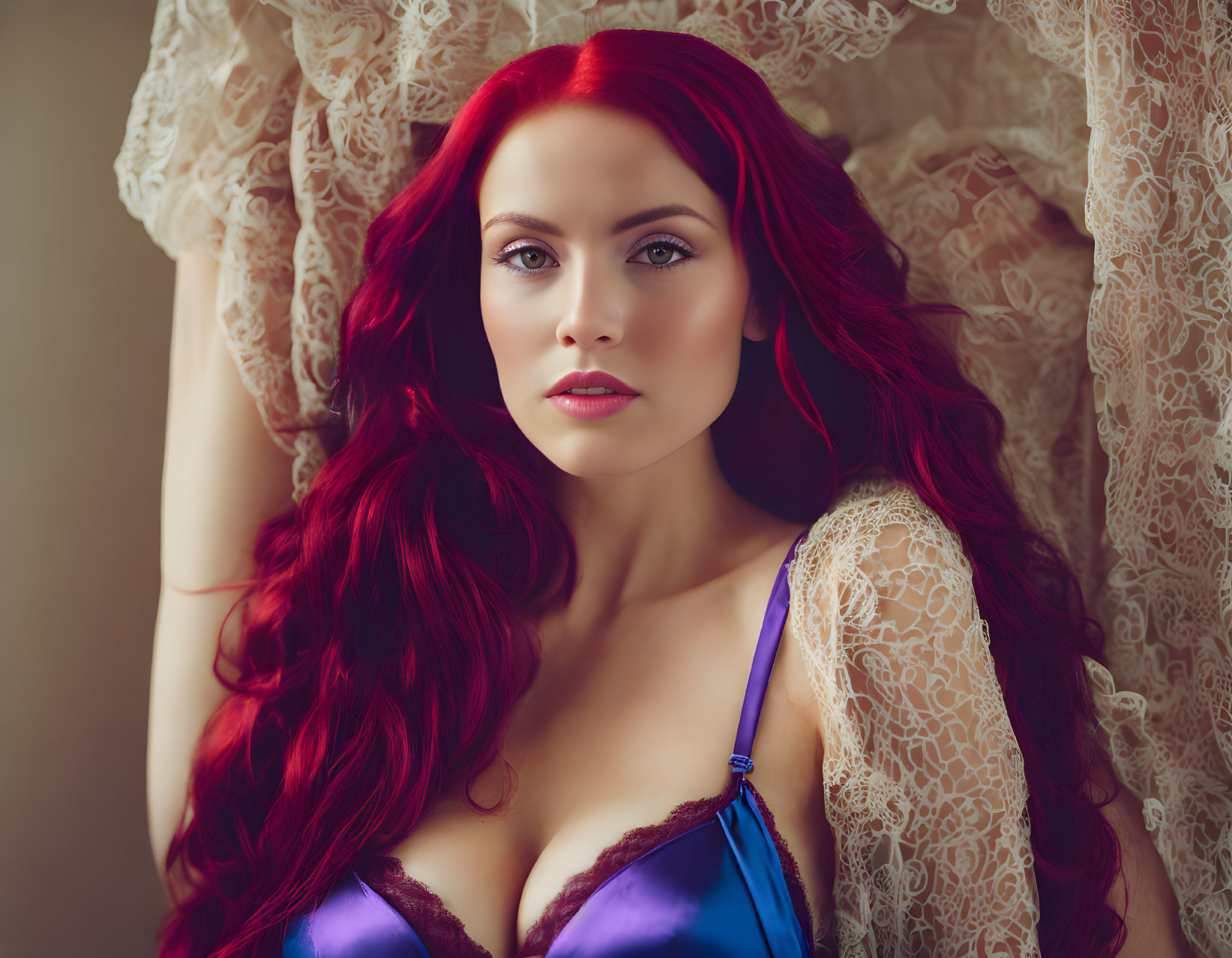 Vibrant red-haired woman in purple top against lace background