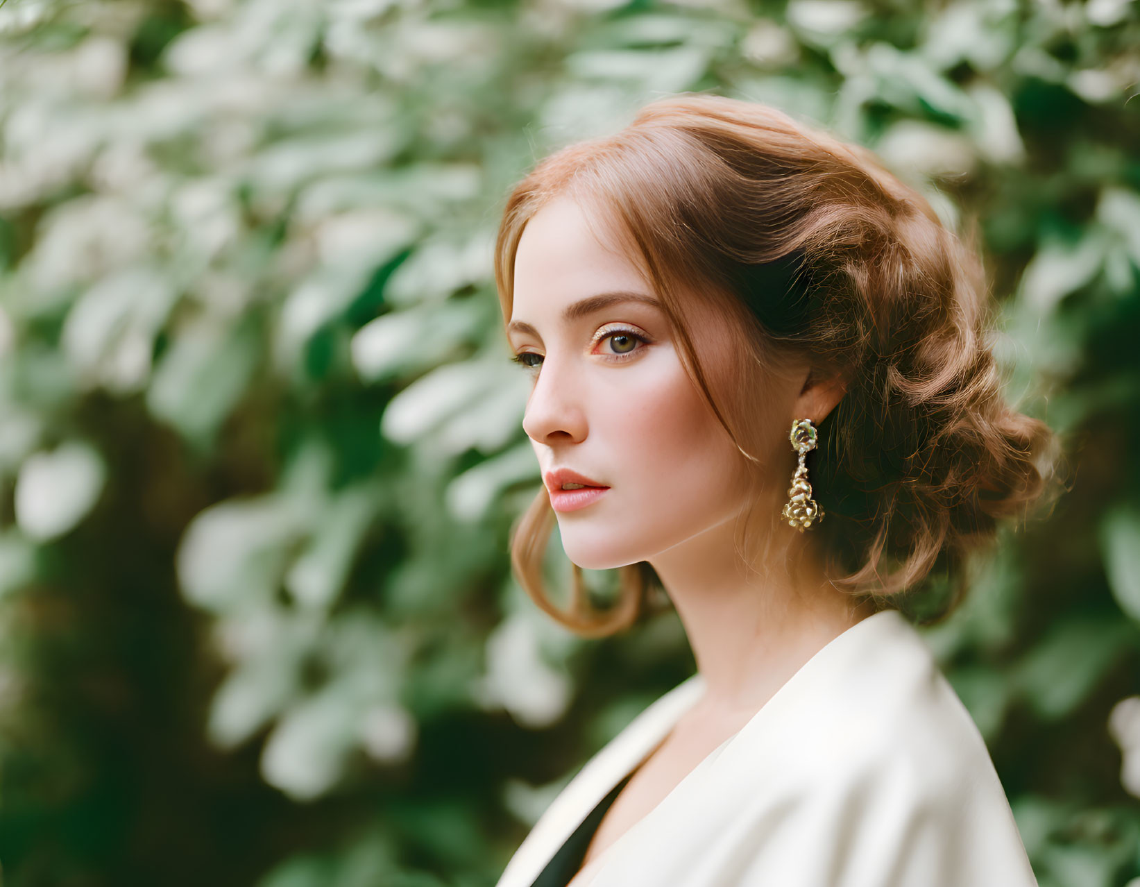 Styled hair woman in white blazer against green backdrop