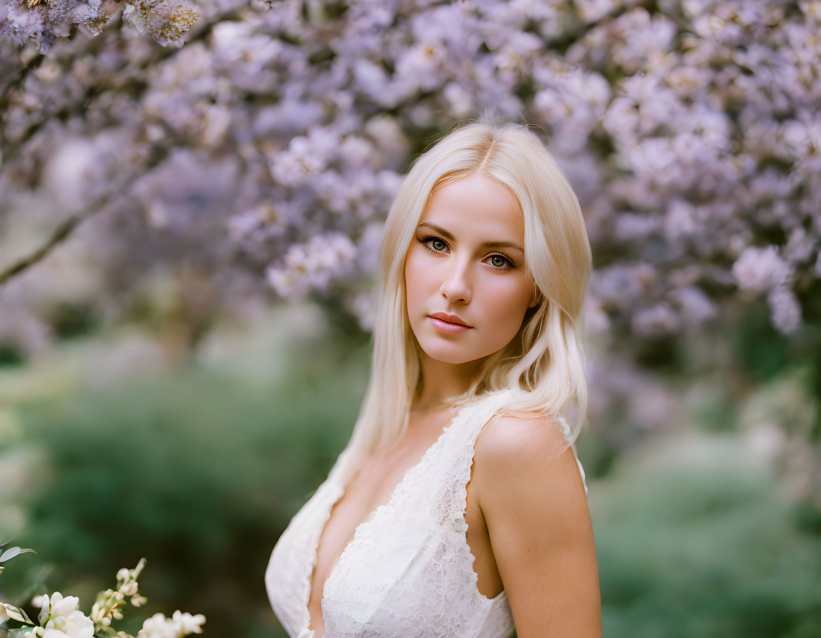 Blonde Woman in White Dress Under Purple Blossoms