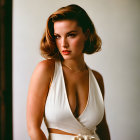 Woman in White Sleeveless Dress with Plunging Neckline Pose Against Soft-Lit Background