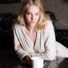 Blonde Woman in Beige Robe with Red Lipstick Holding Mug