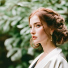 Styled hair woman in white blazer against green backdrop