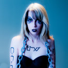 Platinum Blonde Woman with Tattoos and Dark Makeup on Blue Background