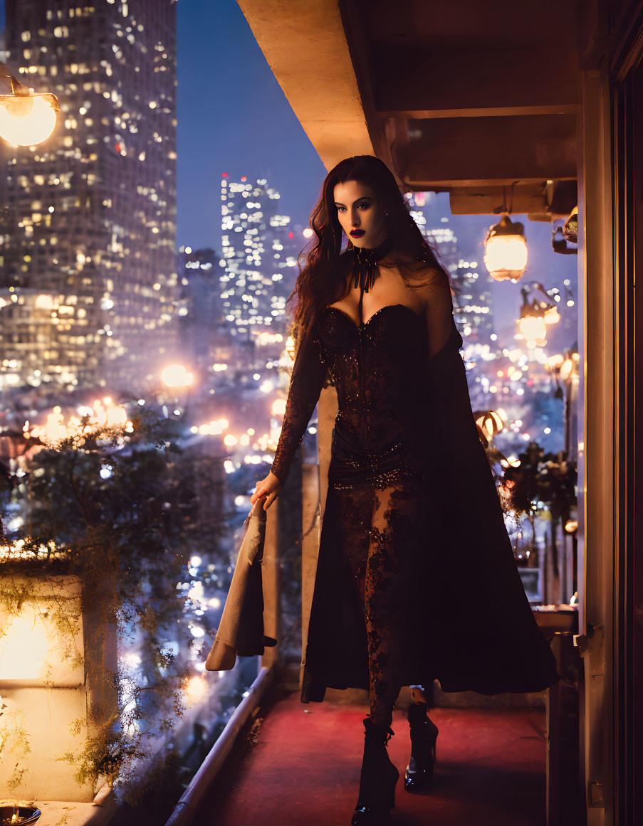 Elegant woman in dark dress on night balcony with city lights