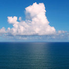 Tranquil seascape: tall ships, gentle waves, vast sky