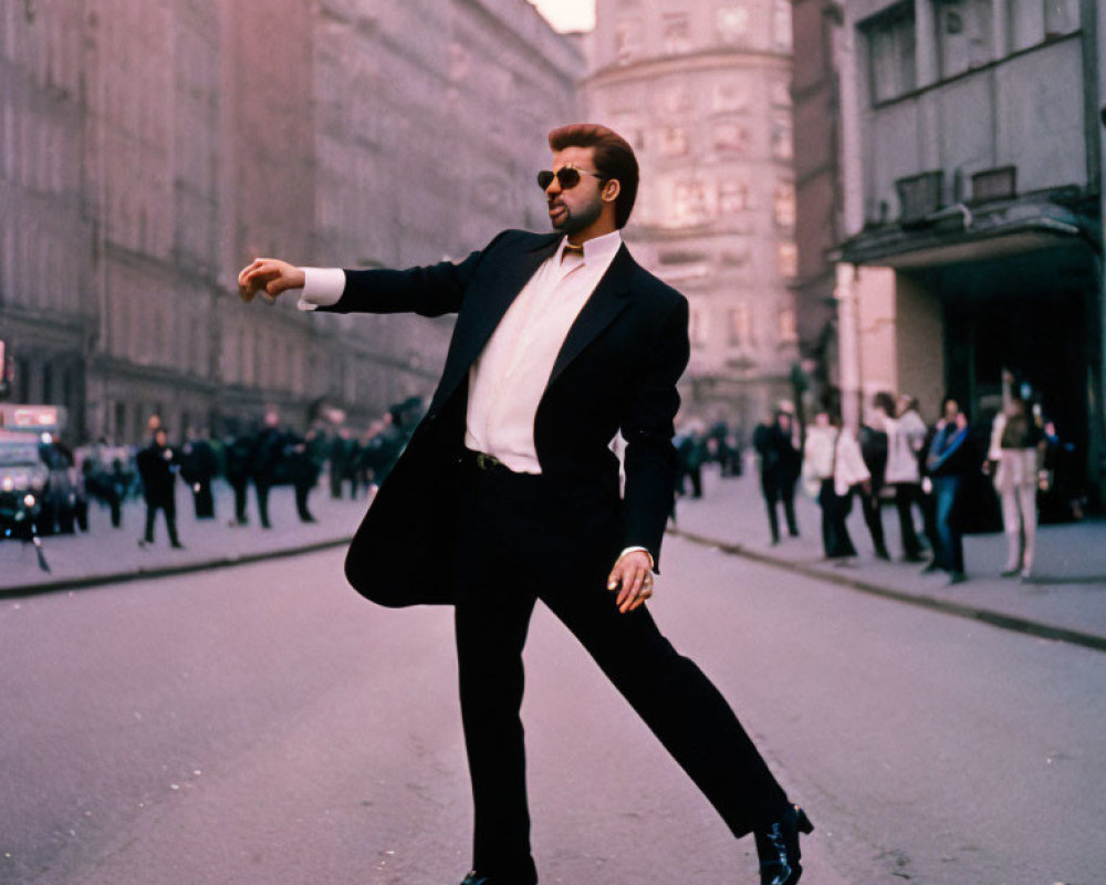 Confident man in black suit and sunglasses on street with bystanders