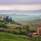 Colorful Village with Church, Castle, and Rolling Hills under Pastel Sky