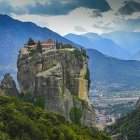 Majestic temples on misty rock pillars under dramatic sky