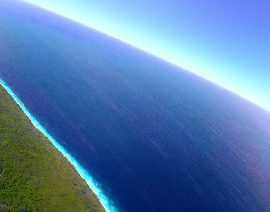 Aerial View of Coastline with Ocean and Green Vegetation