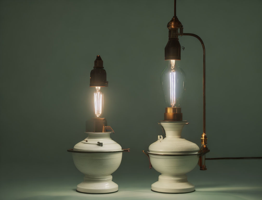 Vintage Oil Lamps with Lit Filaments on Teal Background