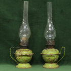 Vintage Oil Lamps with Lit Filaments on Teal Background