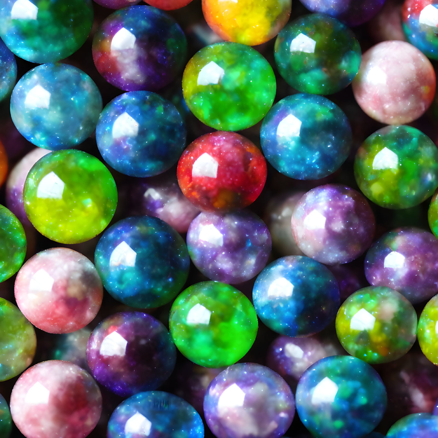 Multicolored Swirling Marbles Reflecting Light in Blue, Green, Yellow, and Pink