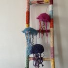 Vibrant jellyfish art with beaded textures on light background