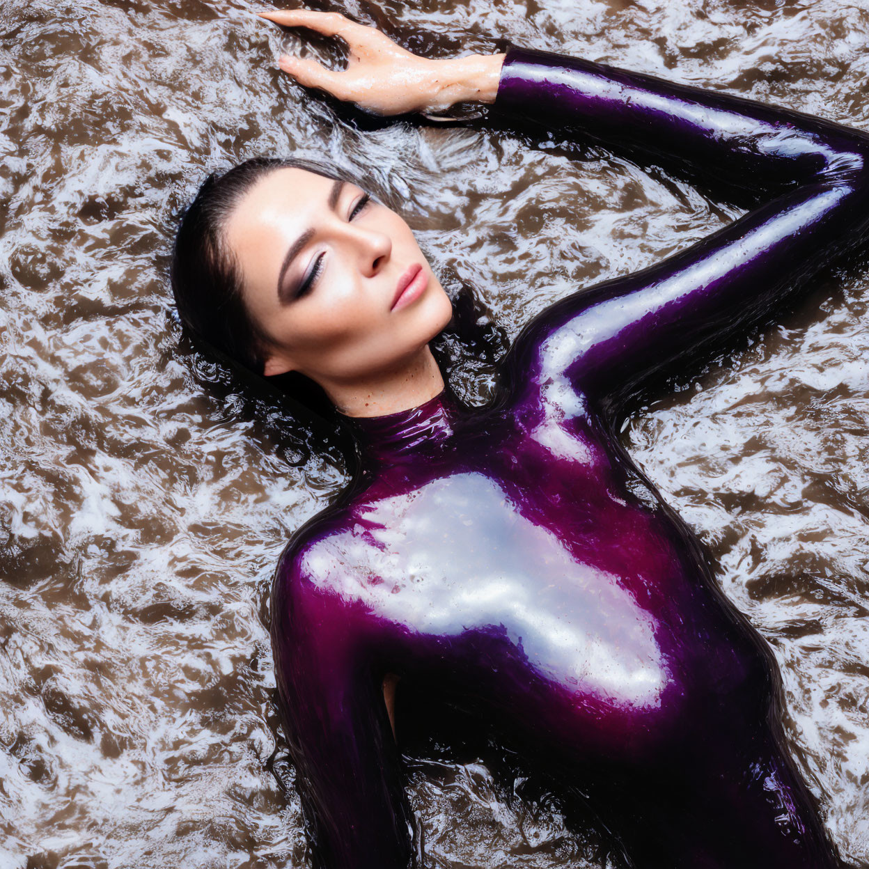 Purple Bodysuit Figure Lying in Water with Eyes Closed