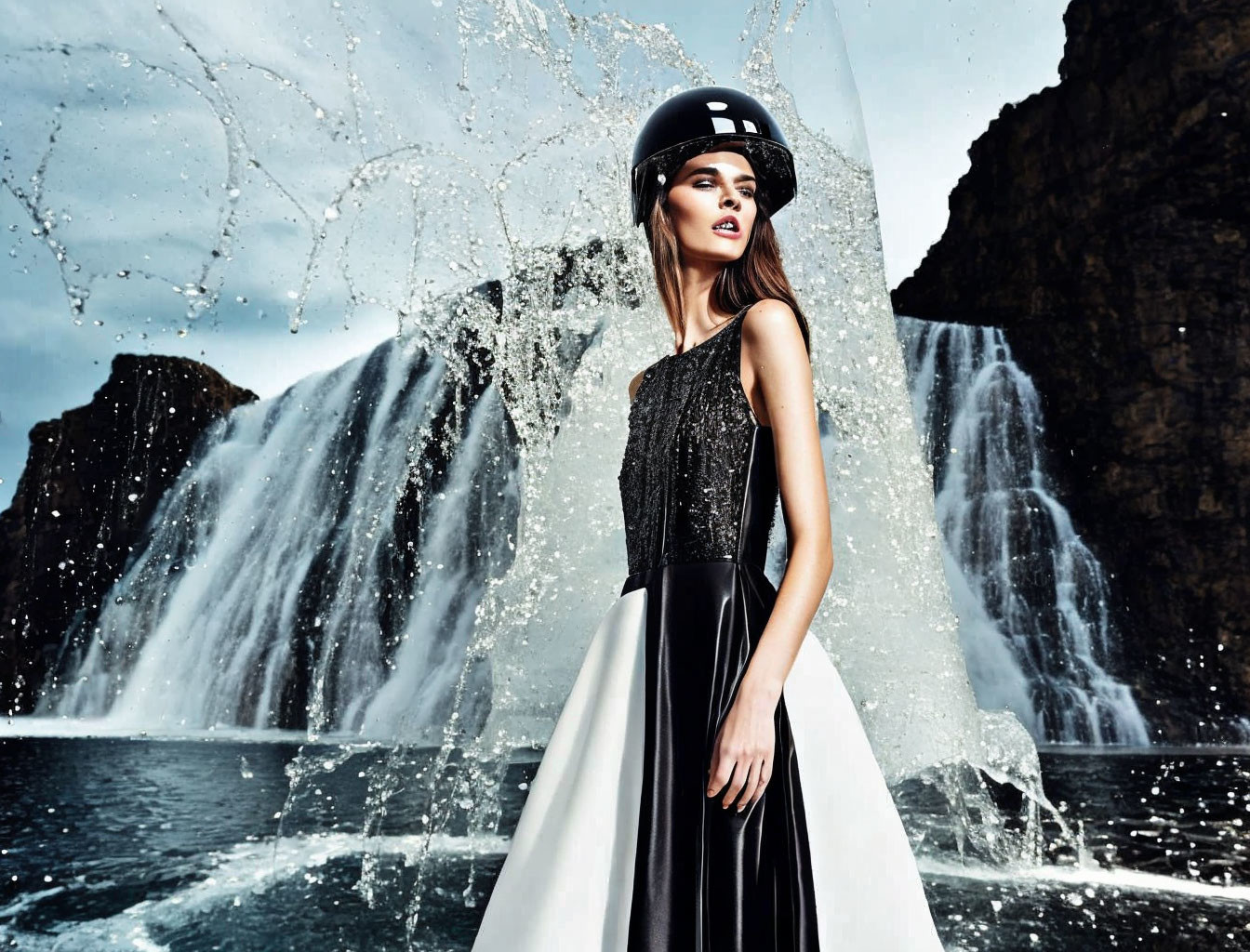 Model in Black and White Dress and Helmet by Dramatic Waterfall