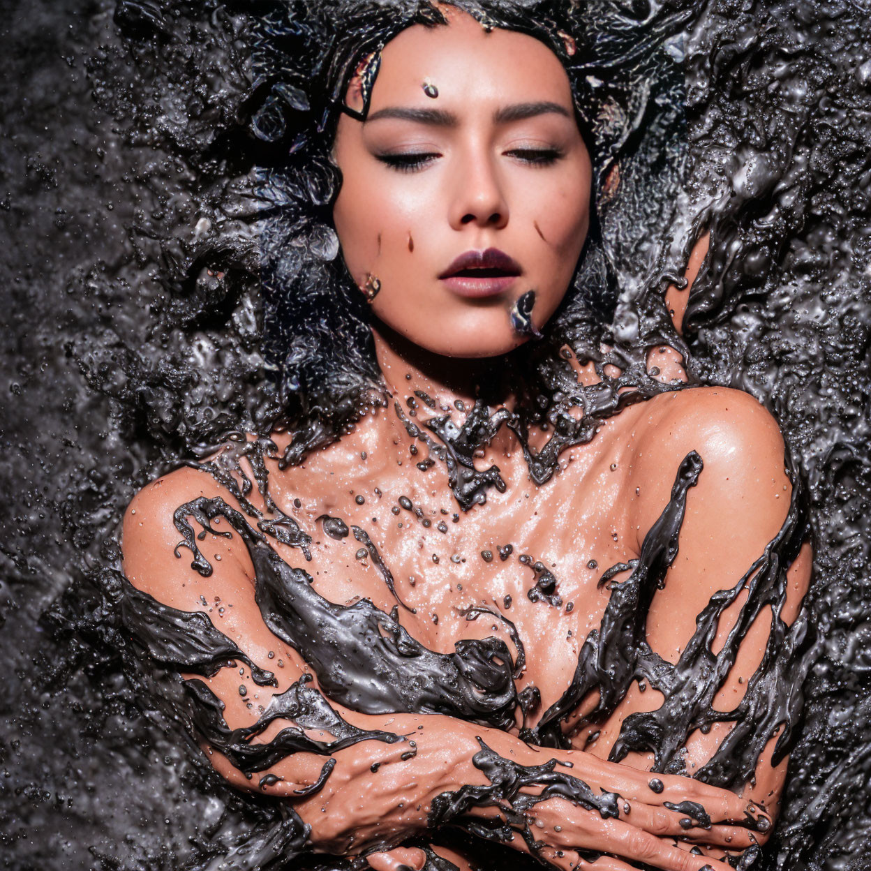 Woman in ornate headwear amidst dynamic water splashes contrast serene expression.