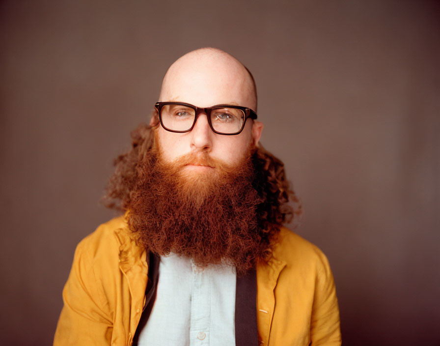 Bald Man with Reddish-Brown Beard in Yellow Jacket Portrait