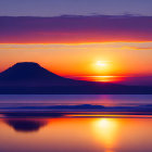 Colorful sunset with sun over horizon, reflecting on water, hill silhouette, pagoda, gradient sky