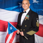 Futuristic military man holding flag in celestial setting