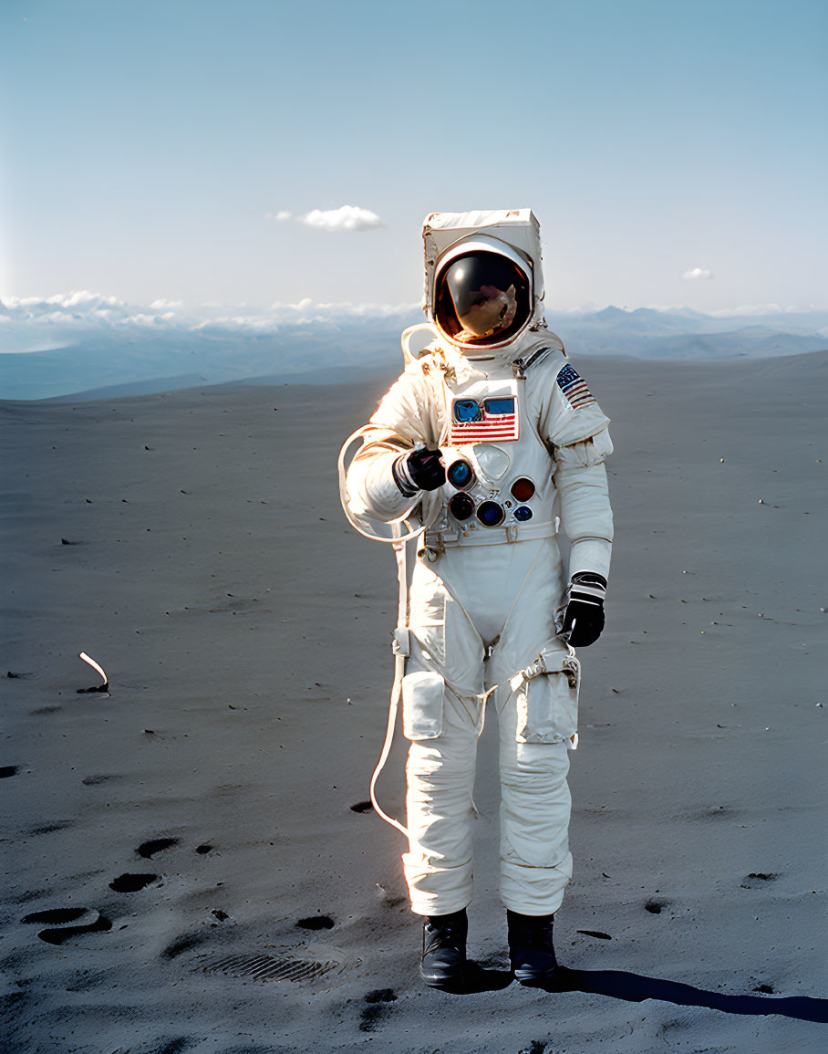 White spacesuit astronaut with American flag on arm on sandy terrain under clear blue sky