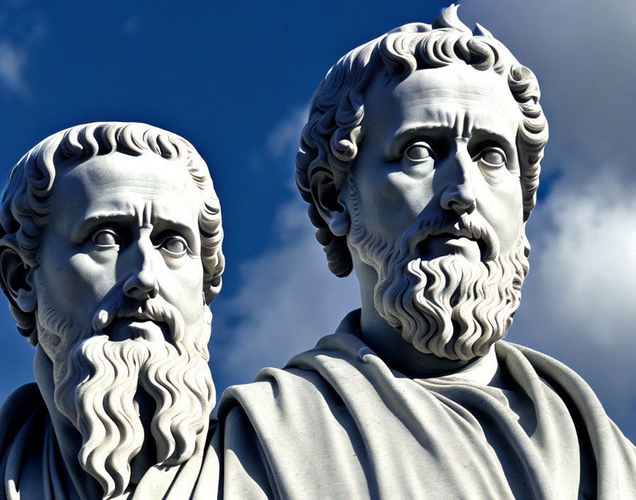 Classical statues of bearded male figures under blue sky