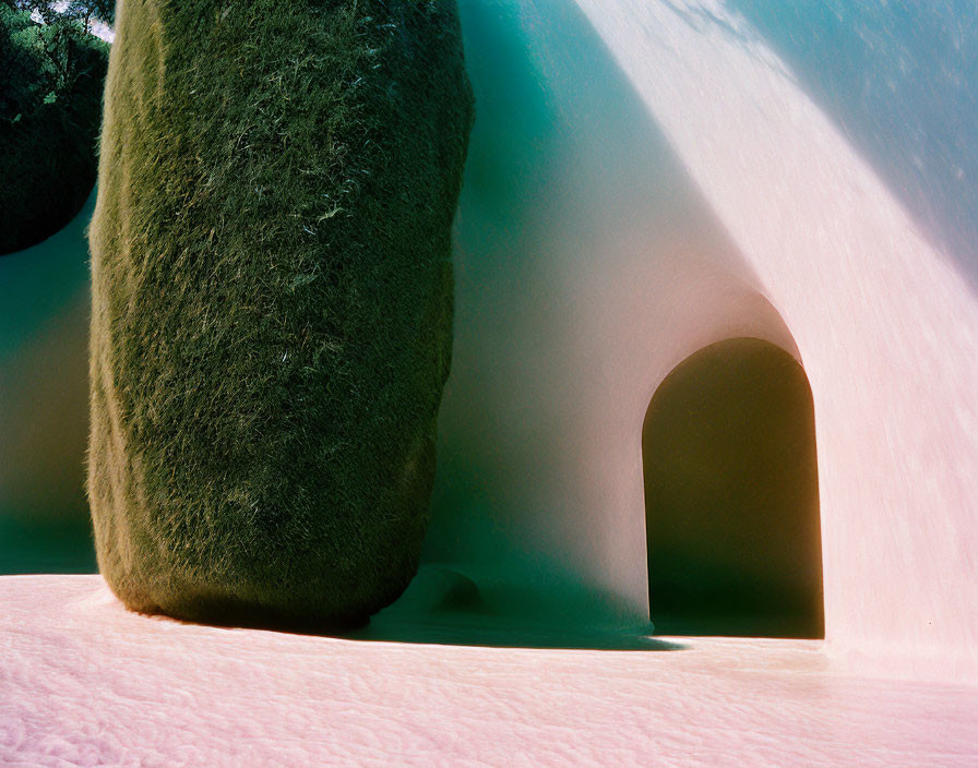 Snow-covered landscape with tunnel-like archway in green hill, contrast of colors and light and shadow play