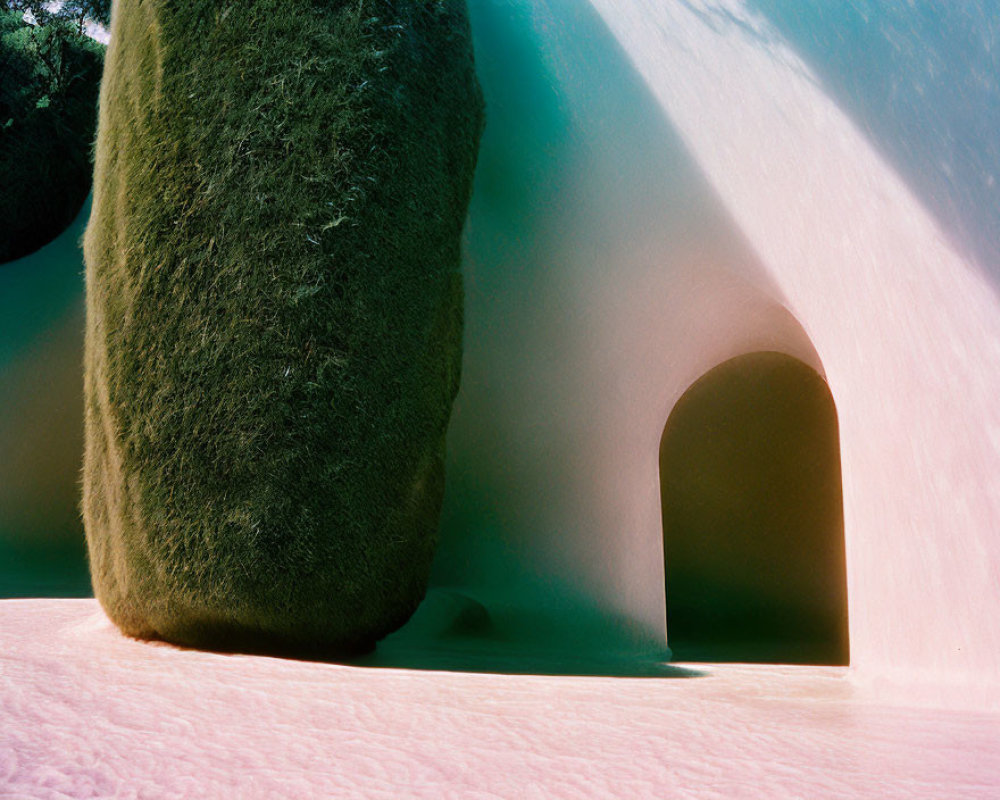 Snow-covered landscape with tunnel-like archway in green hill, contrast of colors and light and shadow play