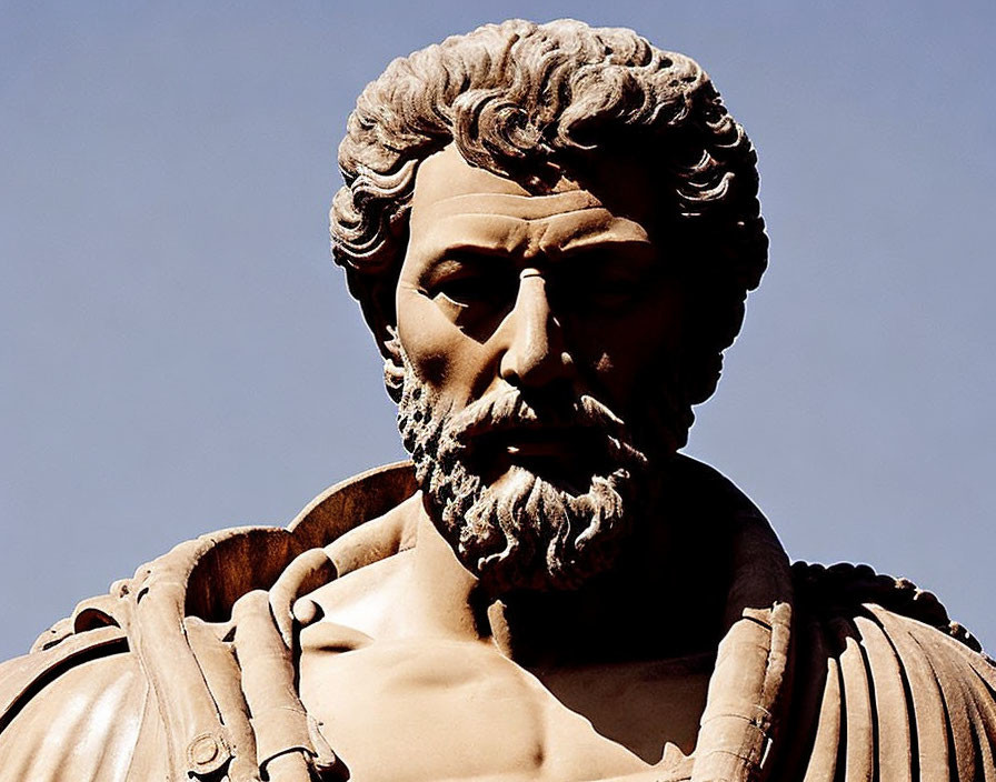 Bearded Man Statue in Armor Under Clear Blue Sky