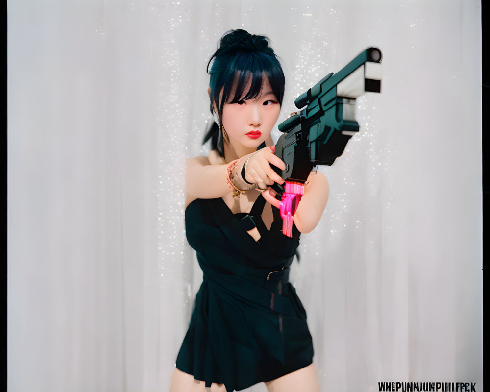 Dramatic pose with toy gun in black outfit against white curtains