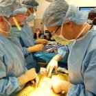 Animated surgeons delicately preparing sushi and sashimi in operating room setting.