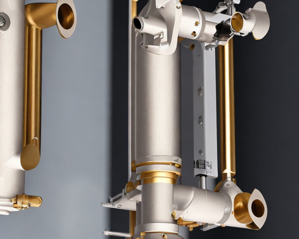 Modern wall-mounted plumbing with metallic pipes and brass fittings on grey background.