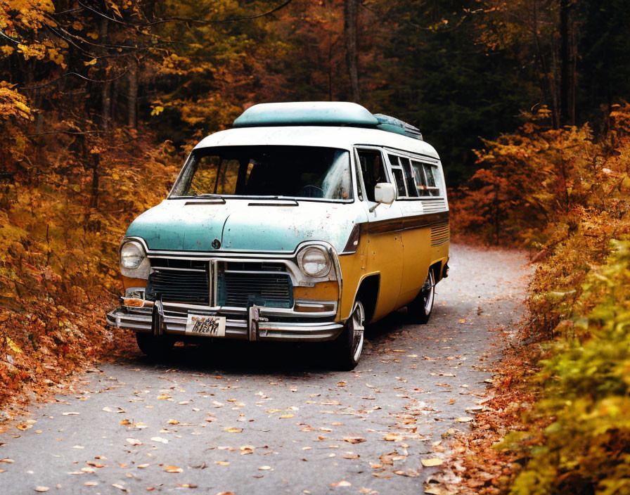 Vintage Teal and Yellow Van Parked on Forest Road Amid Autumn Leaves