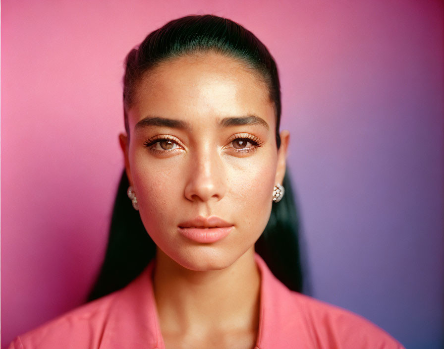 Serene woman portrait on pink and purple gradient background