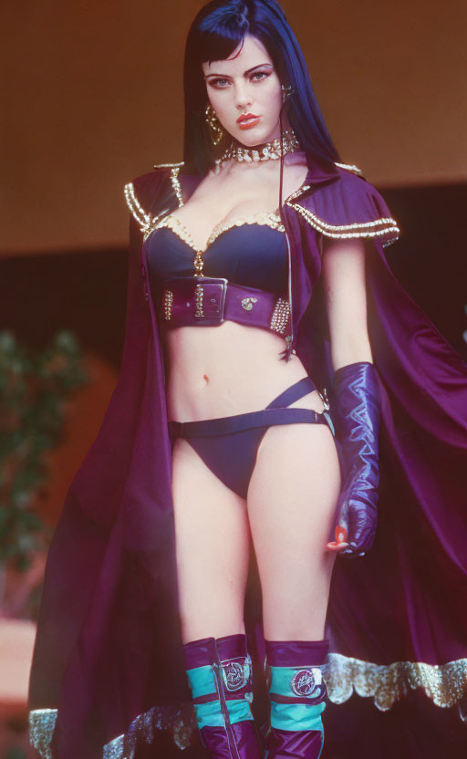 Woman in Purple and Black Costume with Cape and Gold Accents