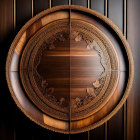 Stylized woman's face split with ornate patterns on circular bronze medallion on wooden backdrop