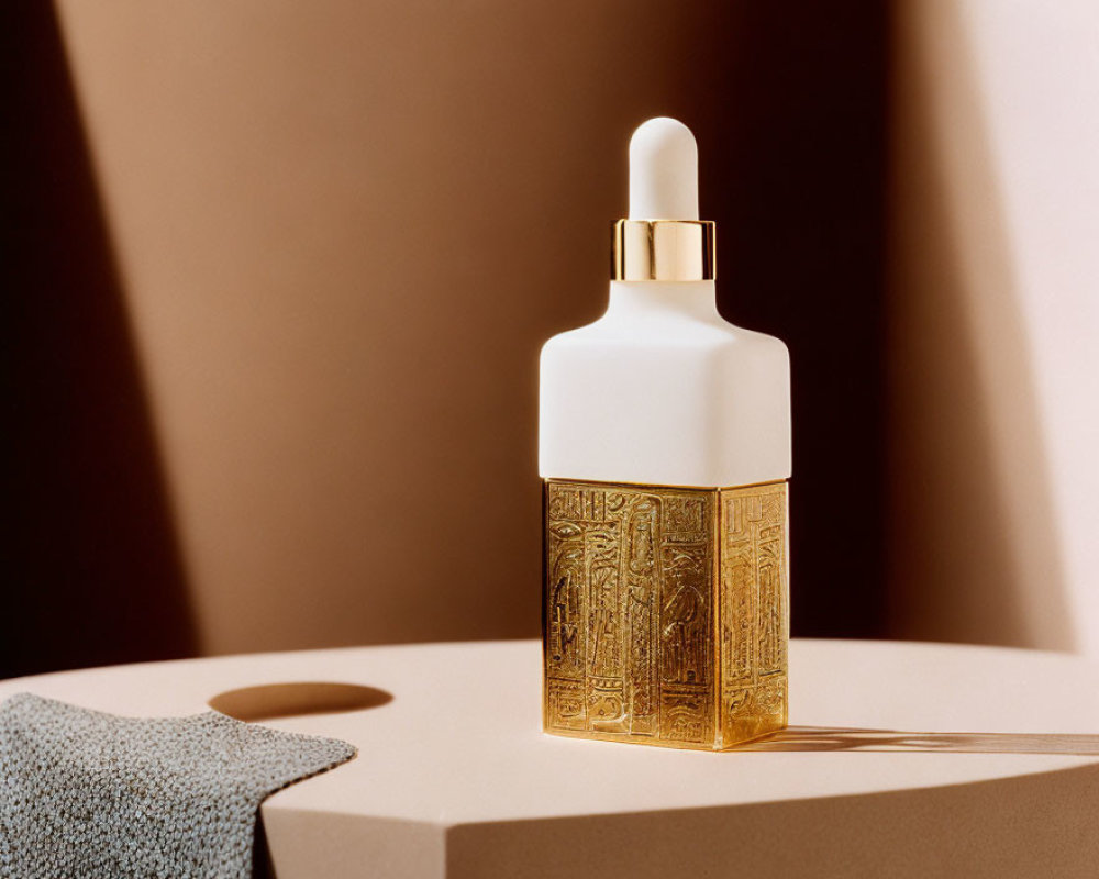 Luxurious Skincare Dropper Bottle with Gold-Textured Base and White Top in Soft Lighting