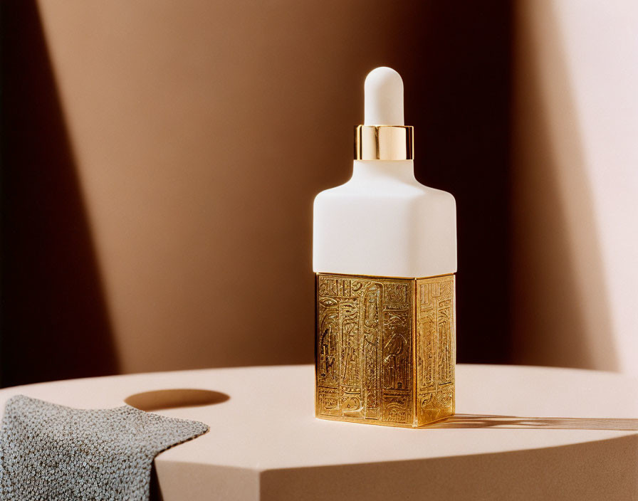 Luxurious Skincare Dropper Bottle with Gold-Textured Base and White Top in Soft Lighting